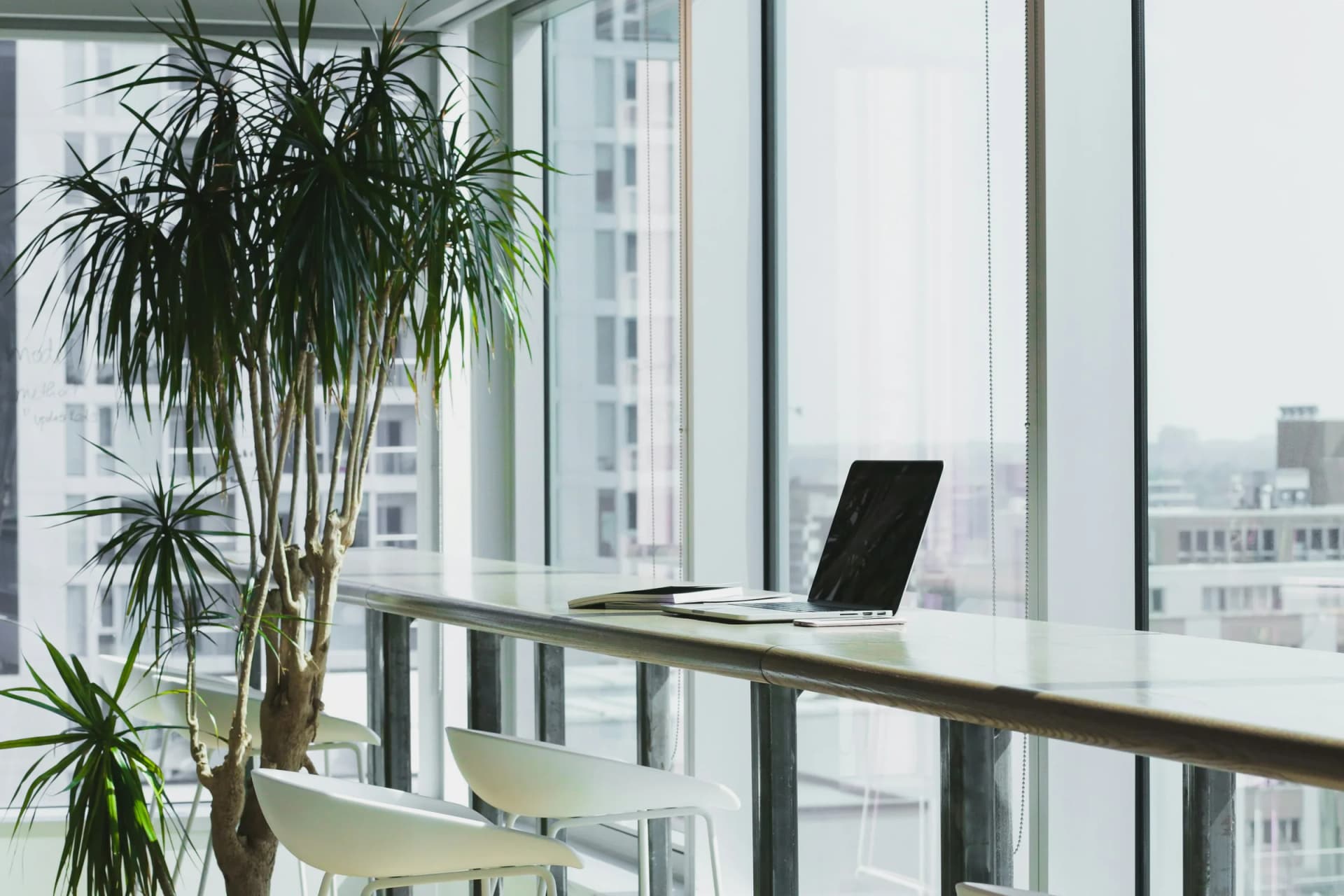 A quiet modern workspace beside a city-facing window